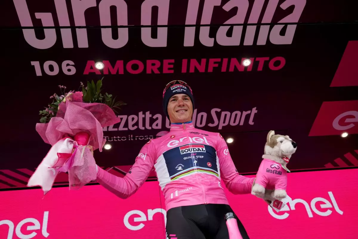 Remco Evenepoel wears the pink jersey of the race overall leader