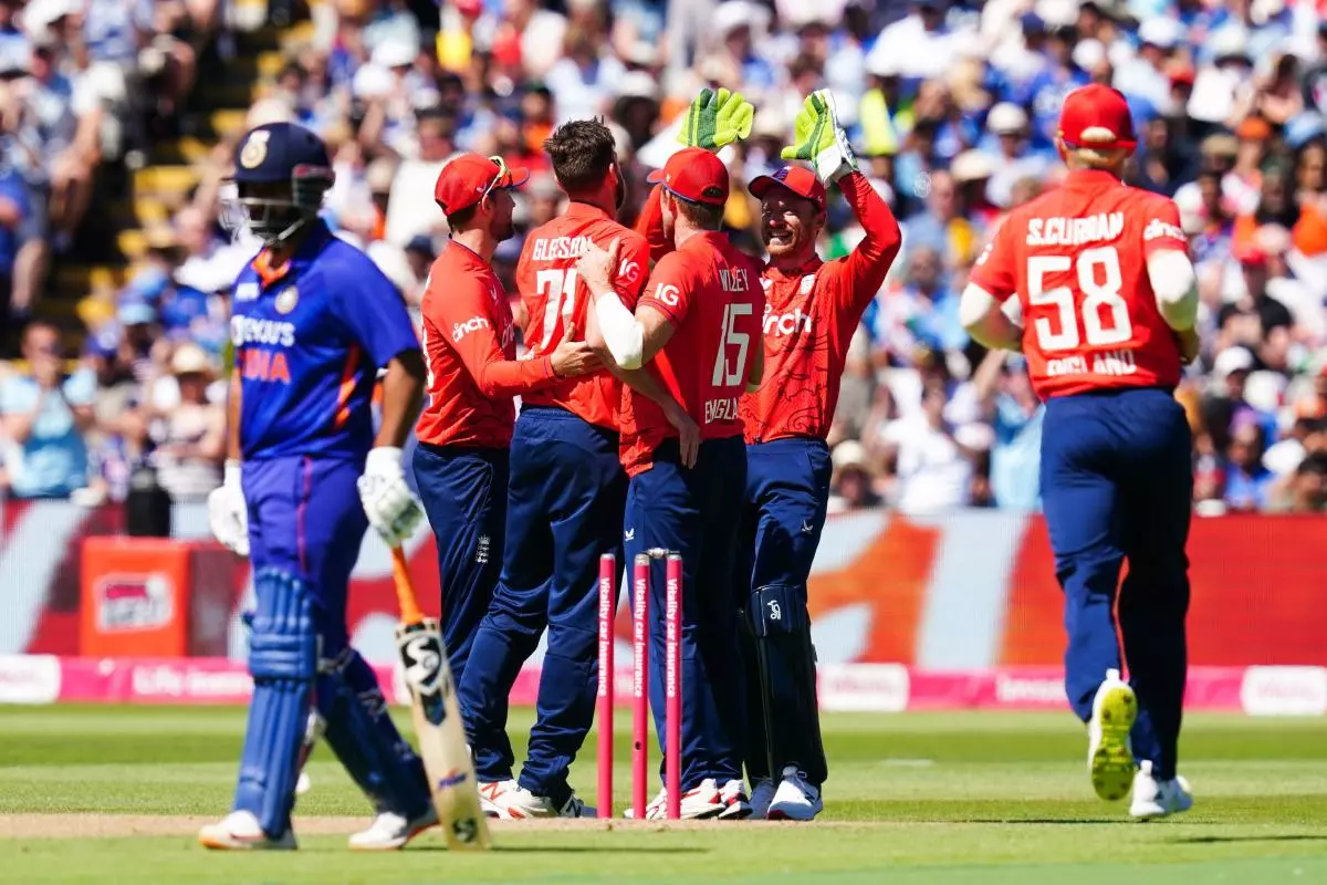 England’s Richard Gleeson and Joe Butler celebrate the wicket of Rohit Sharma