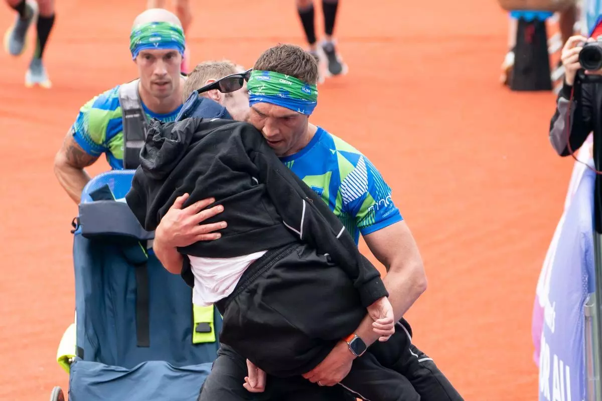Rob Burrow and Kevin Sinfield cross the finish line of the 2023 Rob Burrow Leeds Marathon