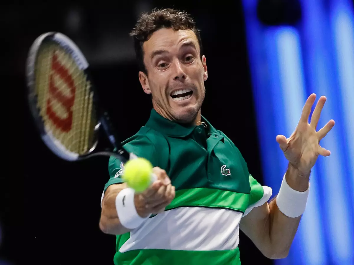Roberto Bautista Agut of Spain returns the ball to Marin Cilic of Croatia during the men's singles quarterfinal tennis match of the ATP 250 St. Petersburg Open