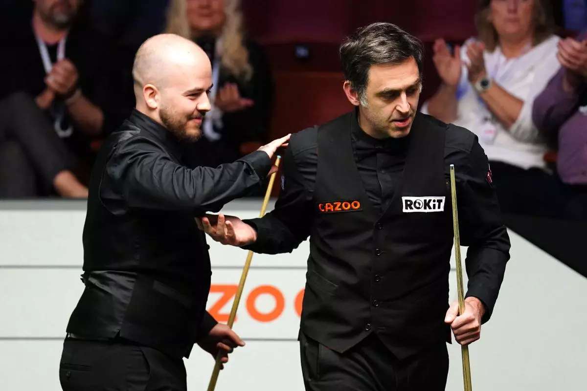 Ronnie O'Sullivan congratulates Luca Brecel at the Cazoo World Snooker Championship - April 2023