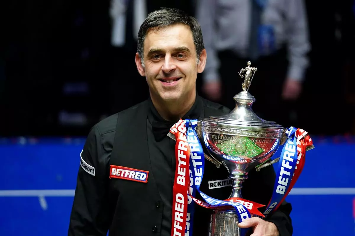 Ronnie O'Sullivan celebrates with the trophy