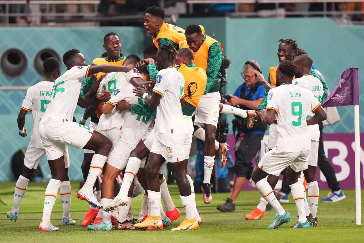 Sarr of Senegal celebrates his goal with his team-mates