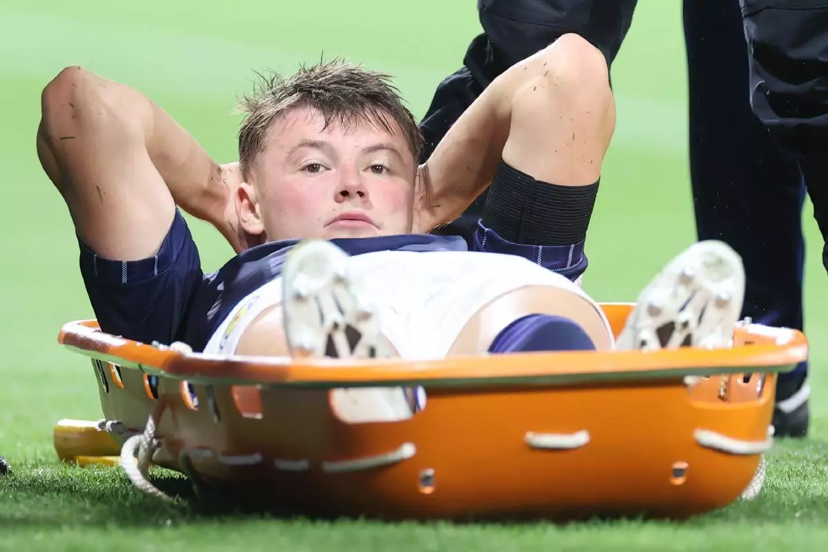 Scotland’s Nathan Patterson goes down injured and then stretchered off the pitch