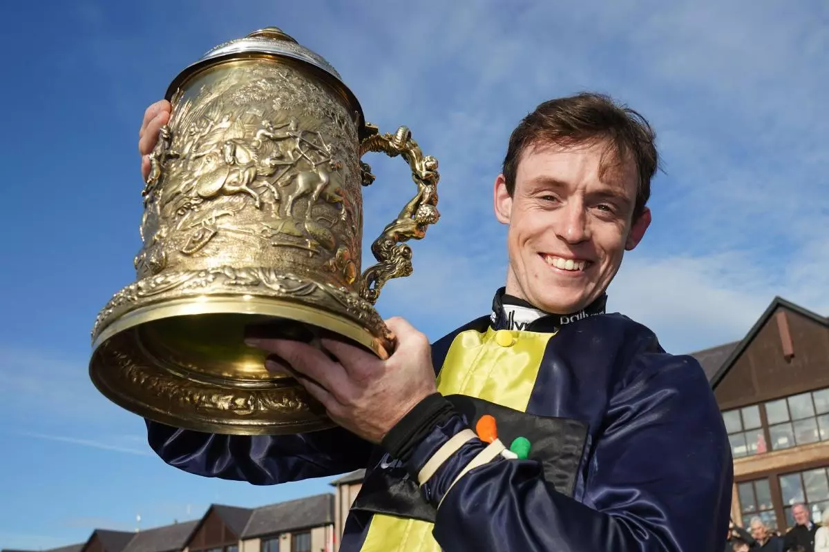 Jockey J J Slevin celebrates with the trophy after winning the Punchestown Gold Cup