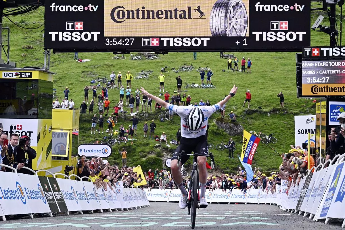 Slovenian Tadej Pogacar of UAE Team Emirates celebrates as he crosses the finish line to win stage 6 of the Tour de France - July 2023