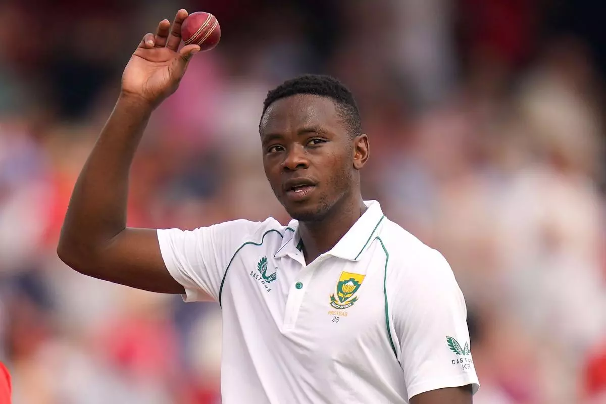 South Africa's Kagiso Rabada walks off with the ball