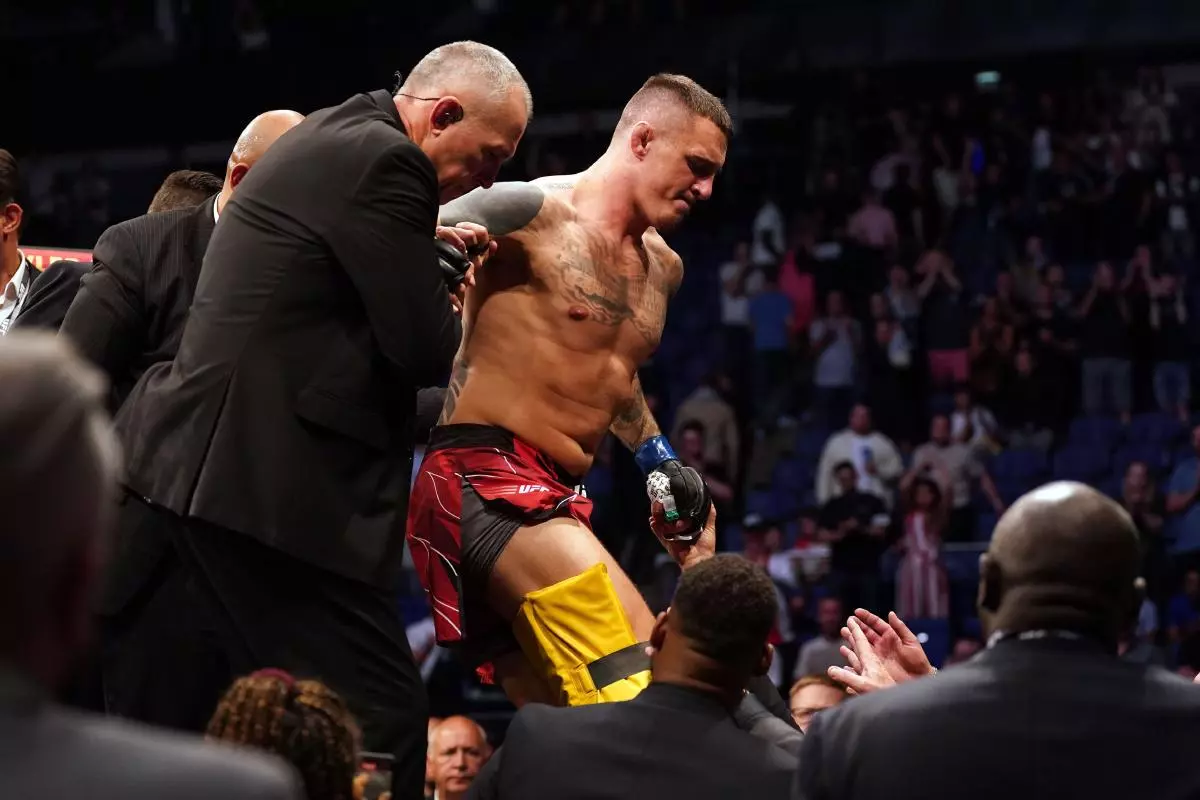 Tom Aspinall is helped out of the ring