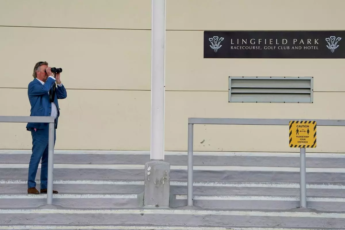 Trainer George Baker watches the action at Lingfield Park Racecourse, Surrey
