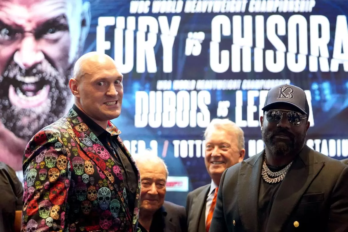 Tyson Fury and Derek Chisora (right) following a press conference at Tottenham Hotspur Stadium