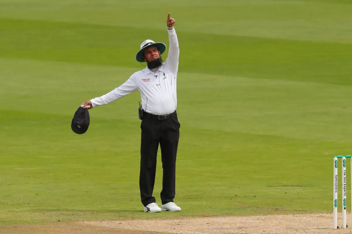 Umpire Aleem Dar points to the Spidercam as it was in the batsmans line of sight