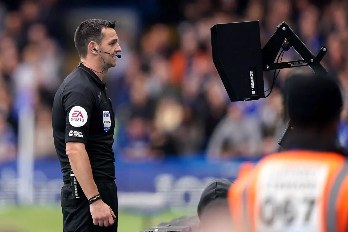 Referee Andrew Madley reviews the VAR screen
