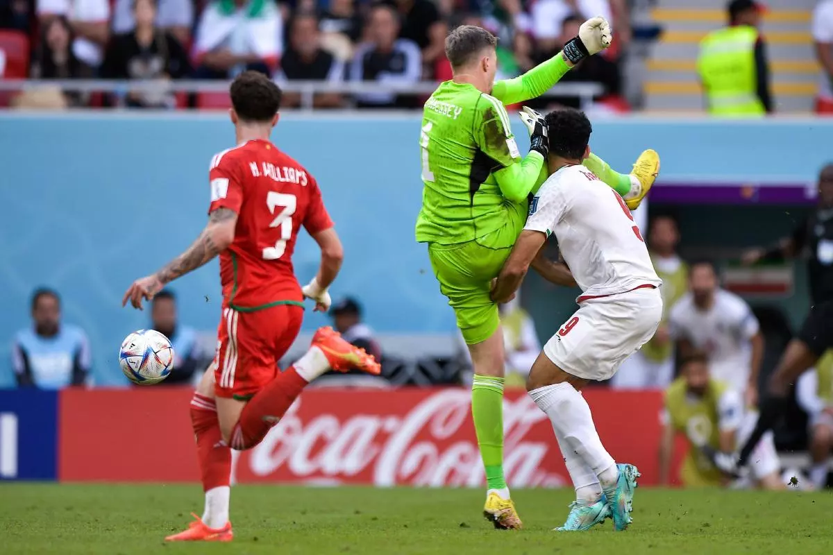 Wayne Hennessey of Wales battles for the ball with Mehdi Taremi of IR Iran during the Group B - FIFA World Cup Qatar 2022 match between Wales and IR Iran