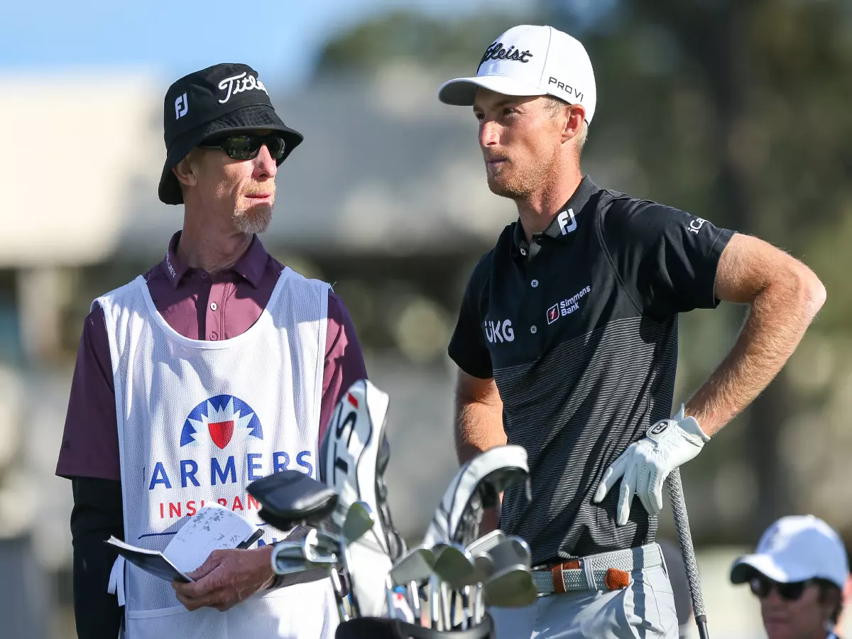 Will Zalatoris (R) and his caddie Ryan Goble wait on the 18th tee during the third round of the 2022 Farmers Insurance Open at Torrey Pines (South) in San Diego, California.