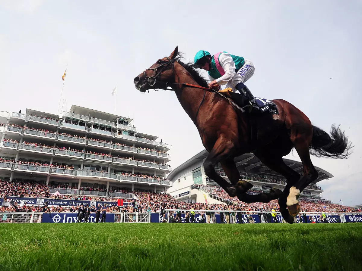 Ryan Moore on Workforce on his way to winning the Investec Derby during Derby Day at Epsom Racecourse