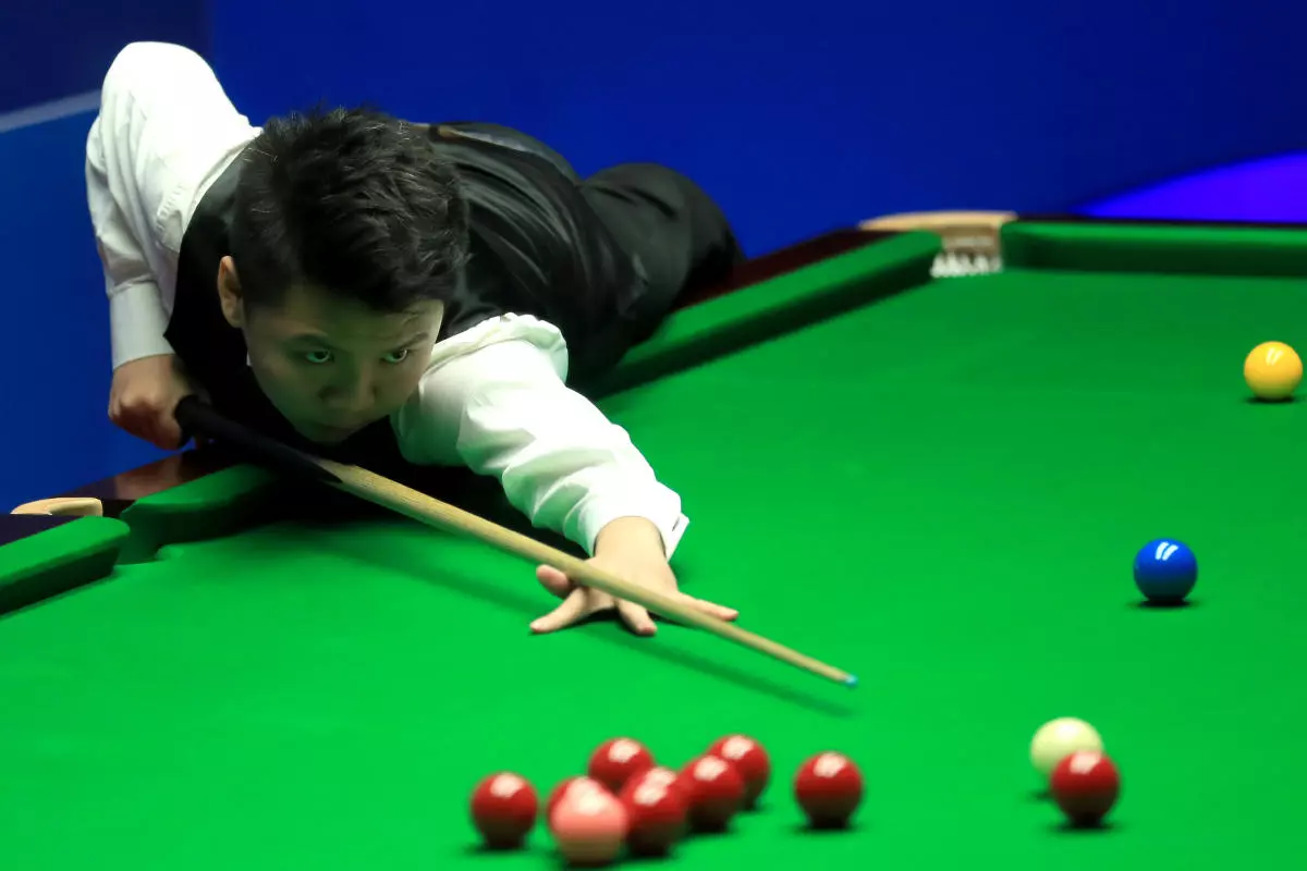 Zhou Yuelong during his match against Ding Junhui on day three of the Betfred Snooker World Championships