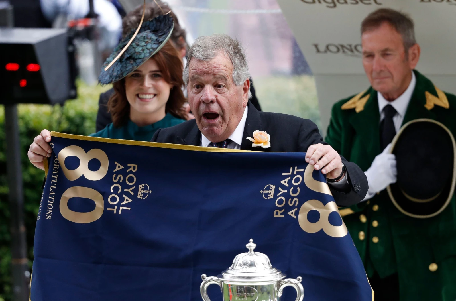 Sir Michael Stoute receives a banner from Princess Eugenie to mark his 80th Royal Ascot winner in 2019