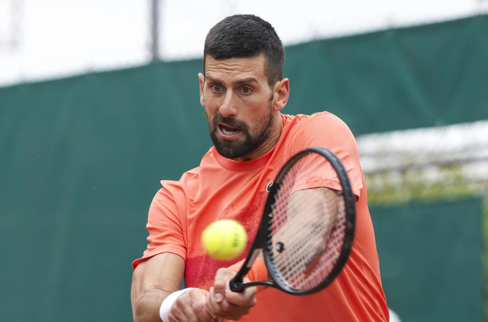Novak Djokovic, of Serbia, hits a return during a training session