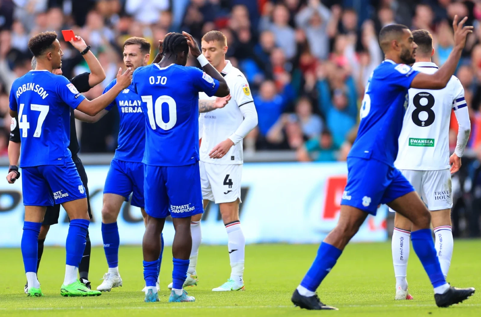Cardiff City's Callum Robinson (left) is shown a red card. Cardiff interim boss Mark Hudson will be without the striker
