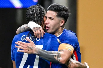 Malo Gusto of Chelsea embraces teammate Enzo Fernandez