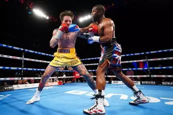 Aaron Chalmers (left) and Floyd Mayweather during their exhibition fight at The O2