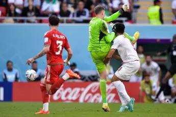 Wayne Hennessey of Wales battles for the ball with Mehdi Taremi of IR Iran during the Group B - FIFA World Cup Qatar 2022 match between Wales and IR Iran