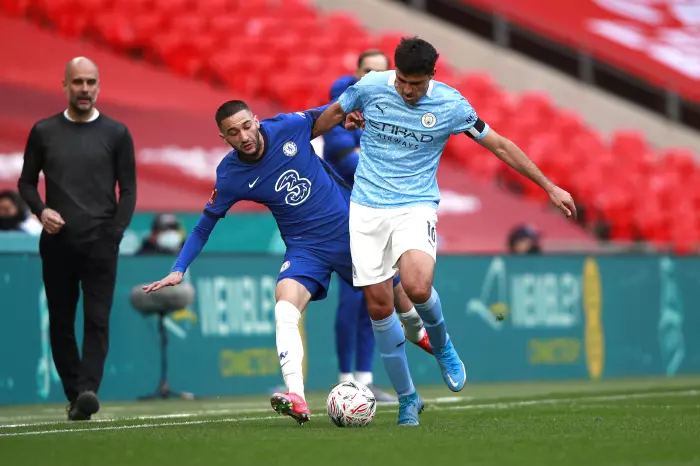 Chelsea's Hakim Ziyech (left) and Manchester City's Rodri battle for the ball during the FA Cup semi final match at Wembley Stadium, London.
