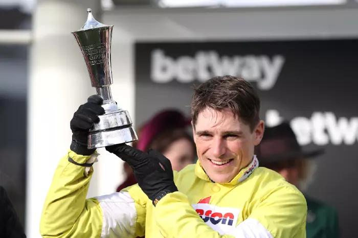 Jockey Harry Skelton holding his prize for winning the Betway Queen Mother Champion Chase during the Cheltenham Festival at Cheltenham Racecourse on March 11, 2020