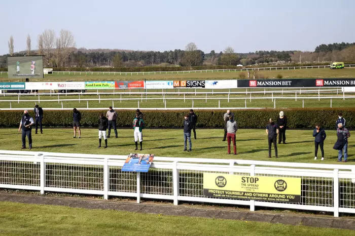 Jockeys, trainers and members of staff at Market Rasen observe a minutes silence in memory of jockey Lorna Brooke