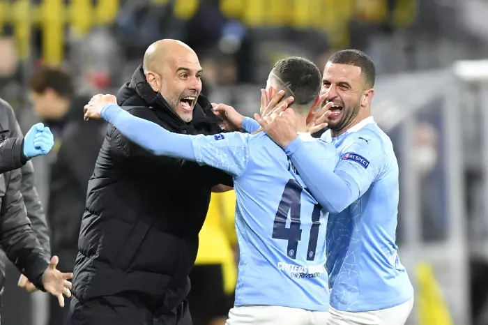 Manchester City manager Pep Guardiola celebrates with goal scorer Phil Foden and Kyle Walker (right) after their second goal during the UEFA Champions League, quarter final, second leg match