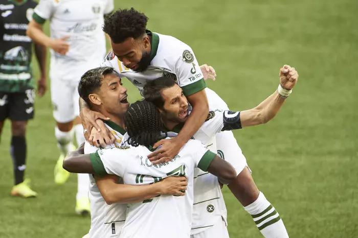 Portland Timbers forward Yimmi Chara (23) celebrates with teammates after scoring a goal during the first half against Marathon at Providence Park.