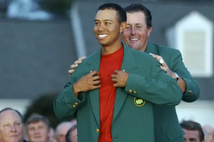 Tiger Woods puts on the Green Jacket after winning the 2005 Masters