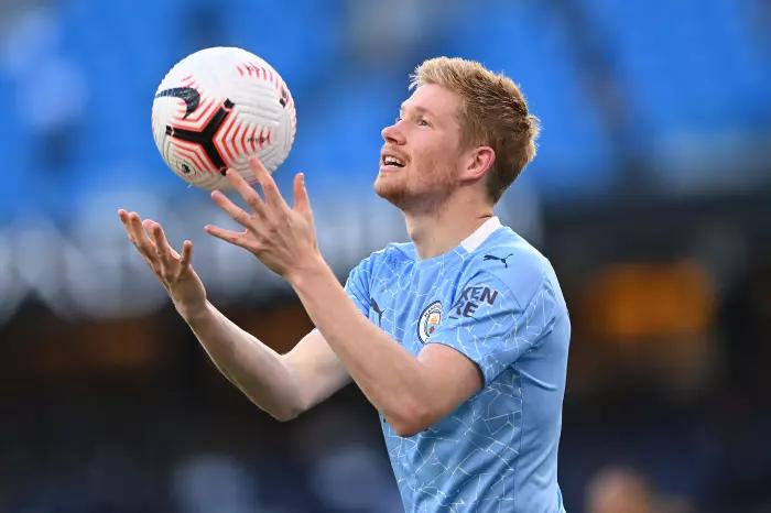 Manchester City midfielder Kevin De Bruyne tosses the ball in the air