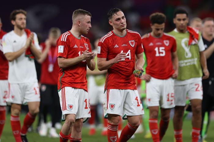 A dejected Joe Morrell and Connor Roberts of Wales