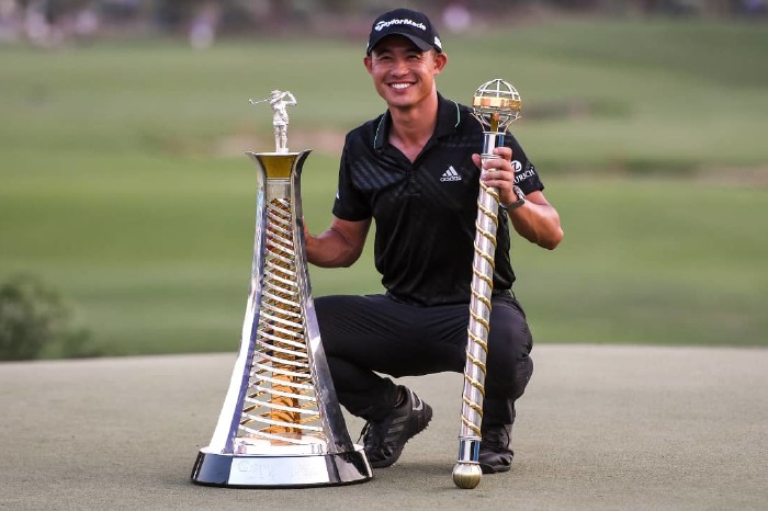 Collin Morikawa with the Race to Dubai and DP World Golf Championship trophies