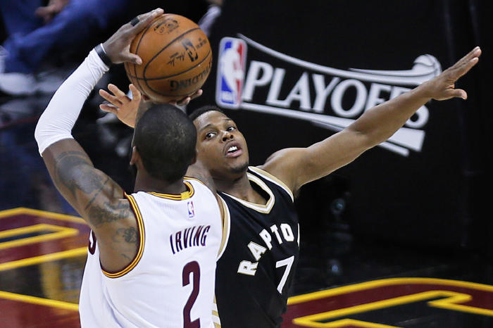 Kyrie Irving shoots a 3-pointer over the Toronto Raptors' Kyle Lowry