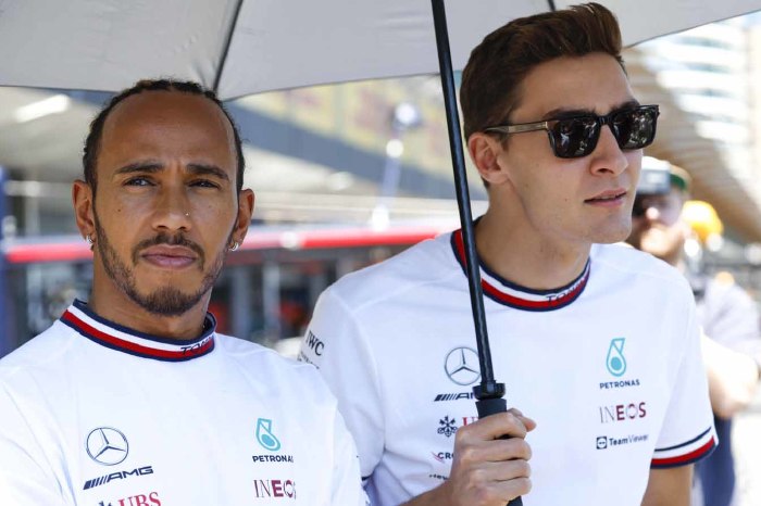Lewis Hamilton and George Russell under an umbrella. Monaco May 2022.