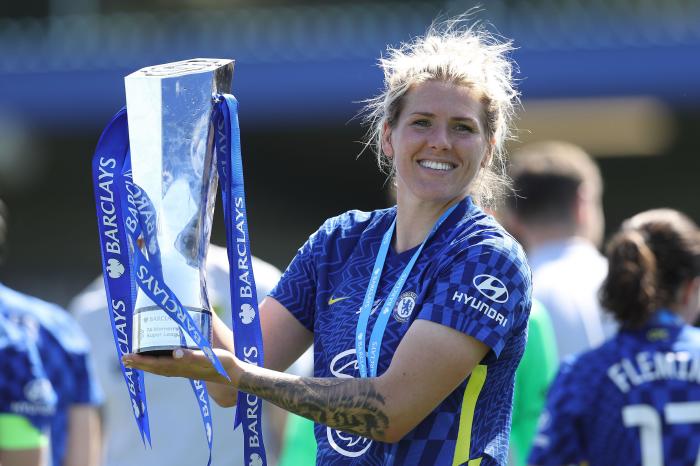 Millie Bright lifting the trophy with Chelsea