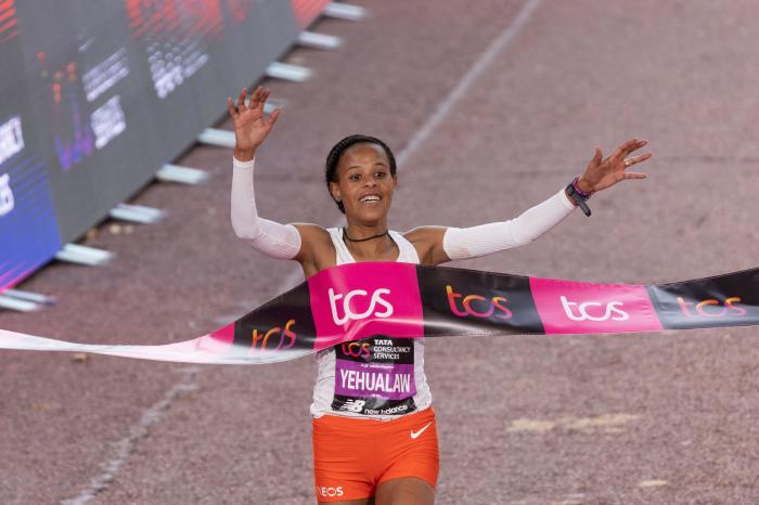 Yalemzerf Yehualaw of Ethiopia celebrates winning the Women's Elite race during the 2022 TCS London Marathon