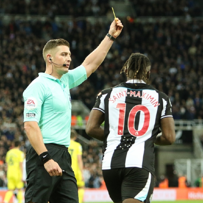 Allan Saint-Maximin receives a yellow card for Newcastle in their draw with Brentford